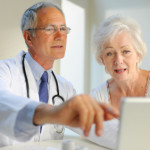 doctor looking at medical-records with patient
